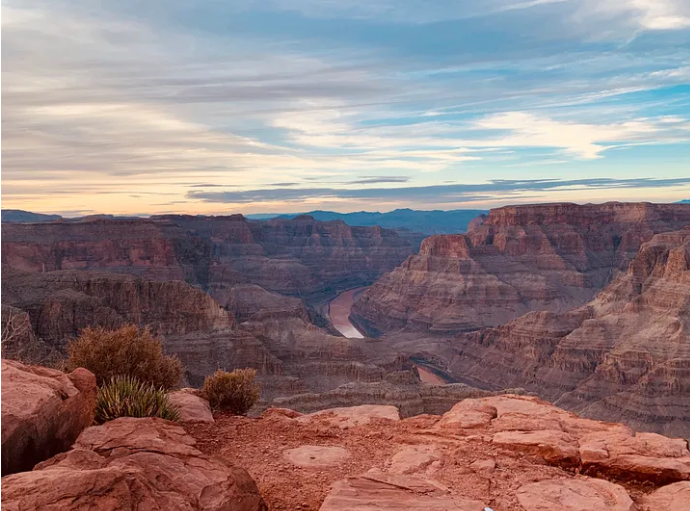 a canyon with a river in the distance